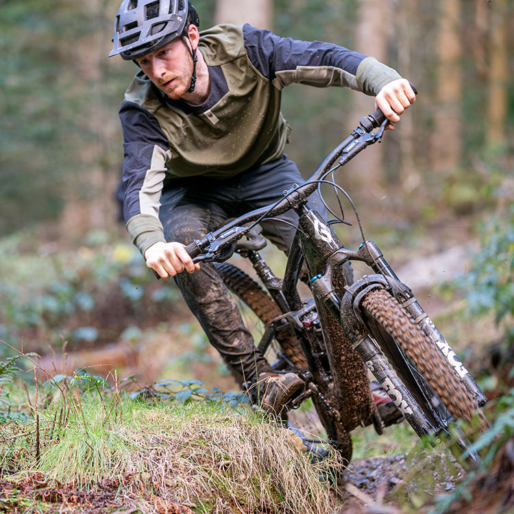 riding teewing enduro mountain ebike through a forest